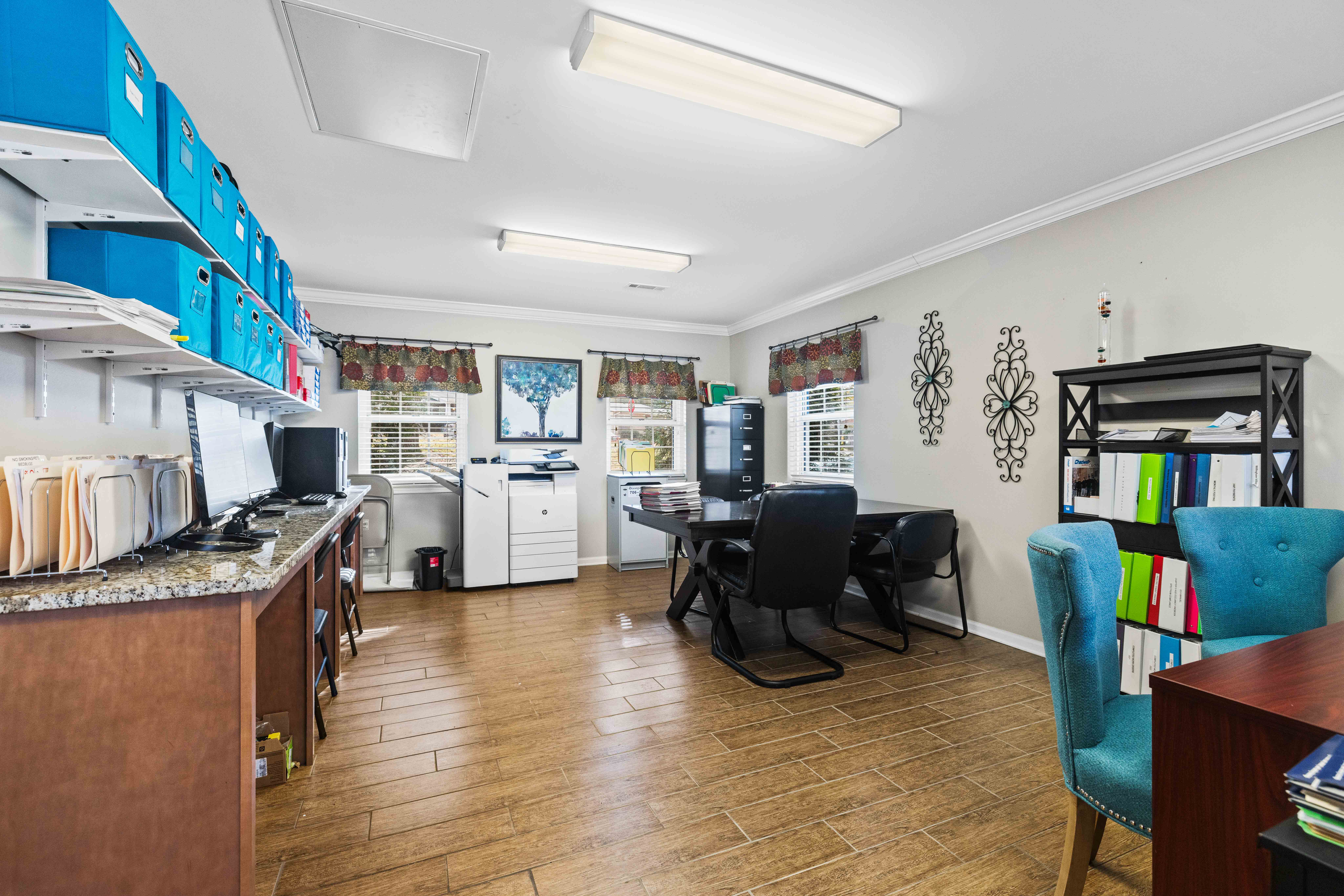 A kitchen with a dining table and chairs.